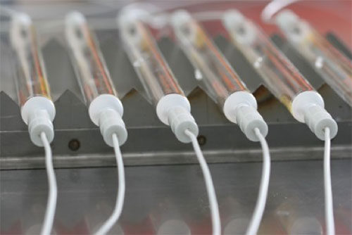 A line of UV curing lamps on the Alpha-Cure production line